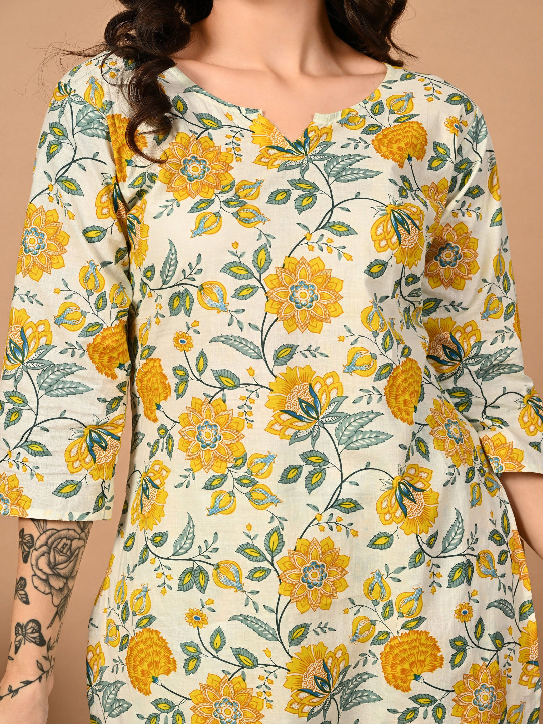 Floral patterned top with yellow flowers on a beige background