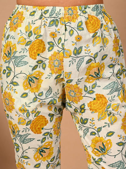 Floral-patterned pants with yellow flowers on a beige background